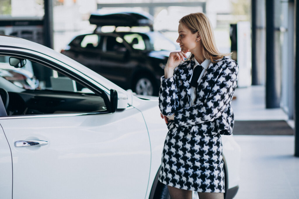 Young business woman choosing a car